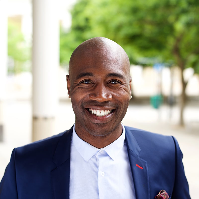 smiling-african-businessman-standing-outdoors-PPMTLXR-min.jpg
